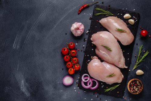 Raw poultry with fresh vegetables