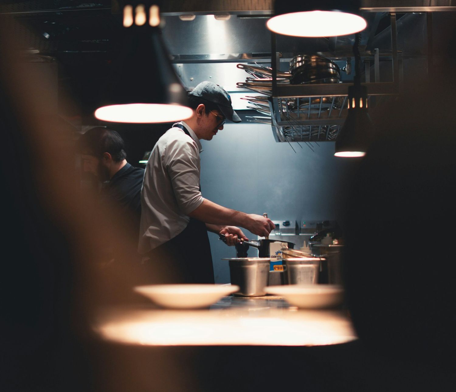 Chef plating a dish in a professional restaurant kitchen